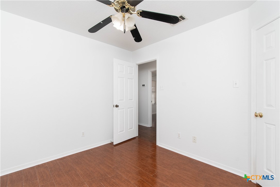 5420 Williams Drive Temple, TX 76502 - Photo 19 of 24 an empty room with a window and a fan