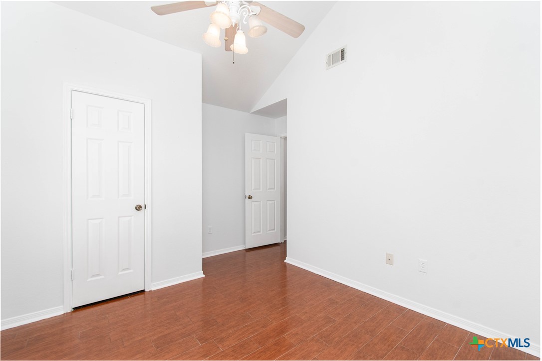 5420 Williams Drive Temple, TX 76502 - Photo 20 of 24 a view of an empty room with wooden floor