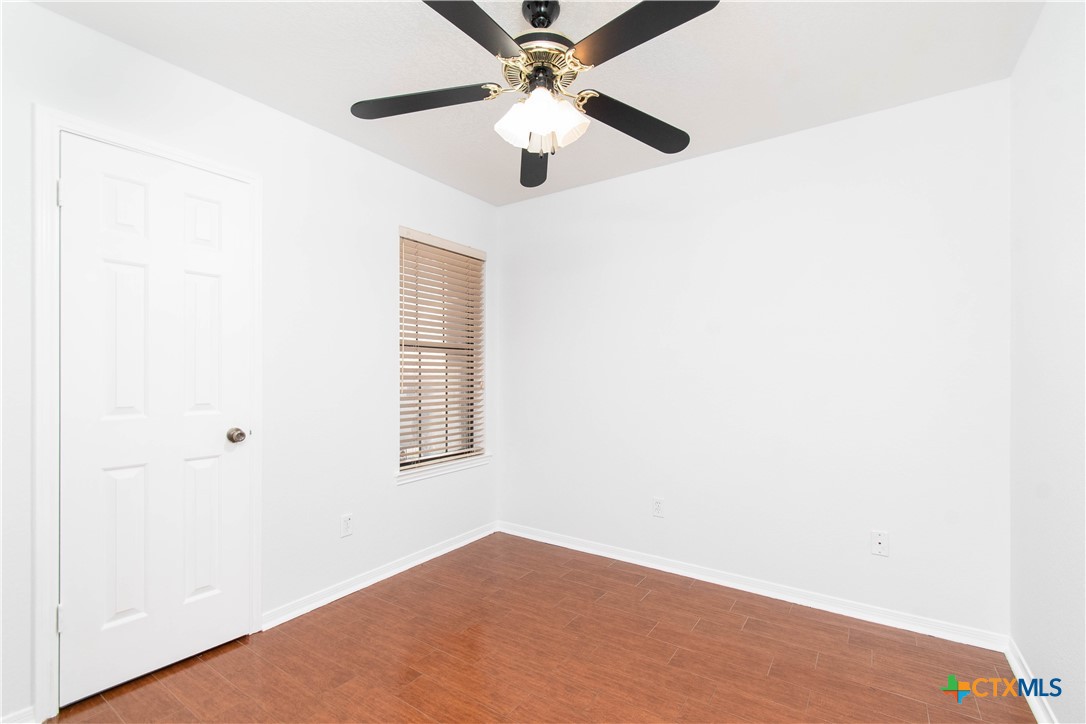 5420 Williams Drive Temple, TX 76502 - Photo 21 of 24 an empty room with a window and a ceiling fan