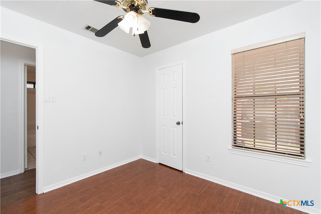 5420 Williams Drive Temple, TX 76502 - Photo 22 of 24 an empty room with a window and a fan
