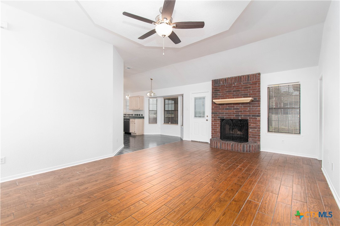 5420 Williams Drive Temple, TX 76502 - Photo 6 of 24 a view of empty room with wooden floor and fireplace