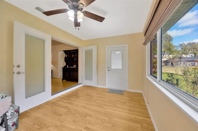 a view of hallway with a large window and chandelier