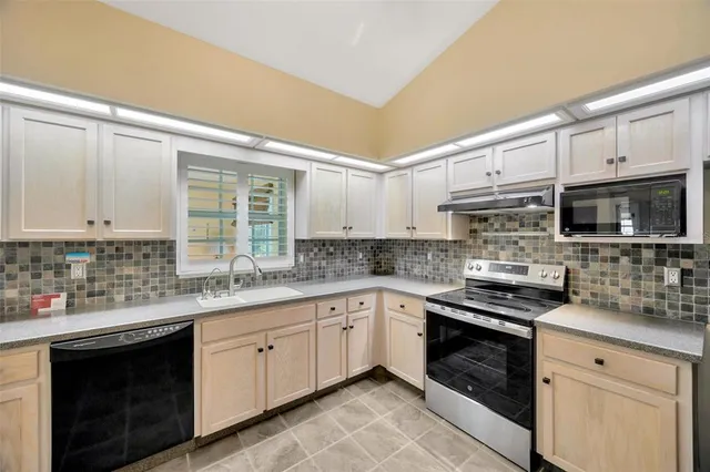 a kitchen with stainless steel appliances white cabinets and a sink