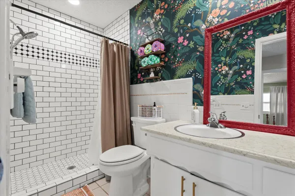 a bathroom with a sink toilet and shower