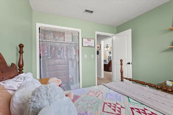 a bedroom with a bed and a chandelier