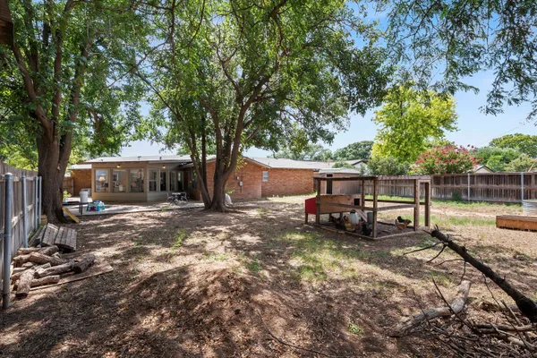 a view of a house with a yard and sitting area