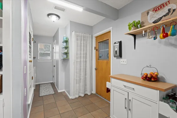 a view of an entryway with wooden floor