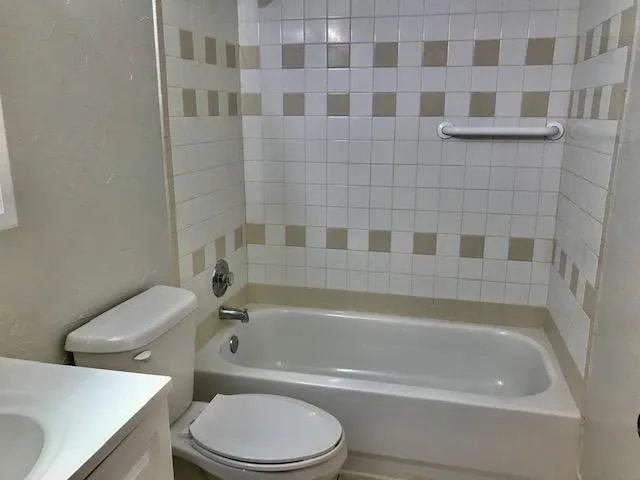 a bathroom with a sink toilet and mirror
