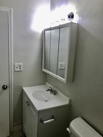 a view of a back yard with the wooden door