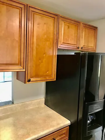 a kitchen with a sink a stove and cabinets