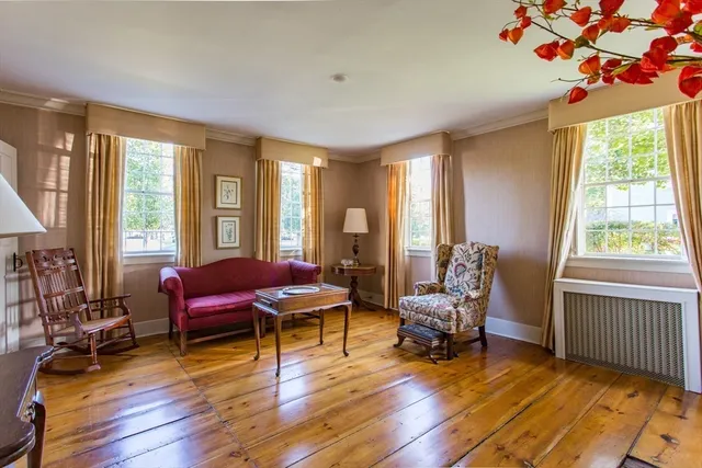 a living room with a fireplace and wooden floor