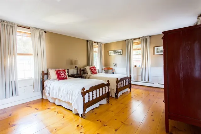 a bedroom with two beds and a window