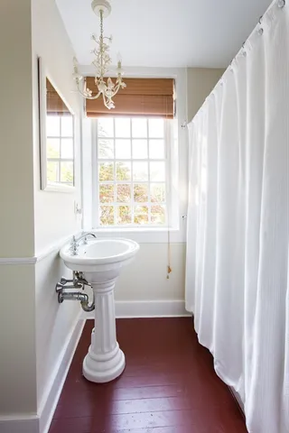 a bathroom with a toilet and a shower