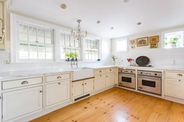 a kitchen with cabinets appliances and a window