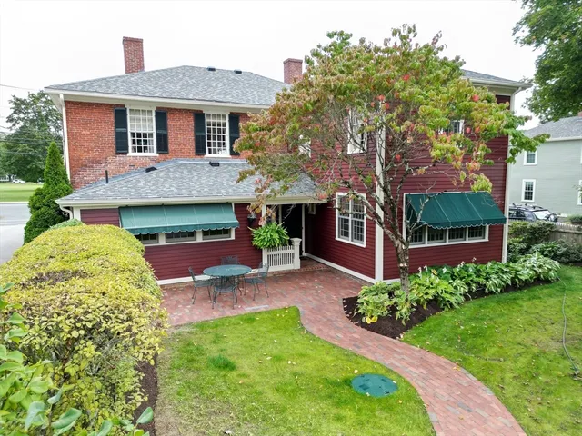 a front view of a house with a garden and plants