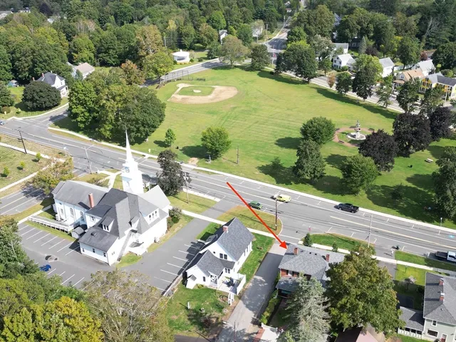 an aerial view of a house with a big yard
