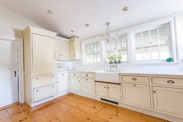 a view of a livingroom with wooden floor and a window