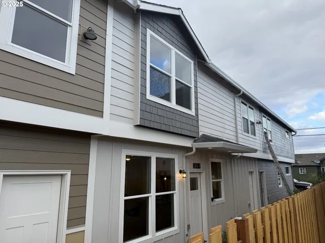 a view of a house with a car park side of a road