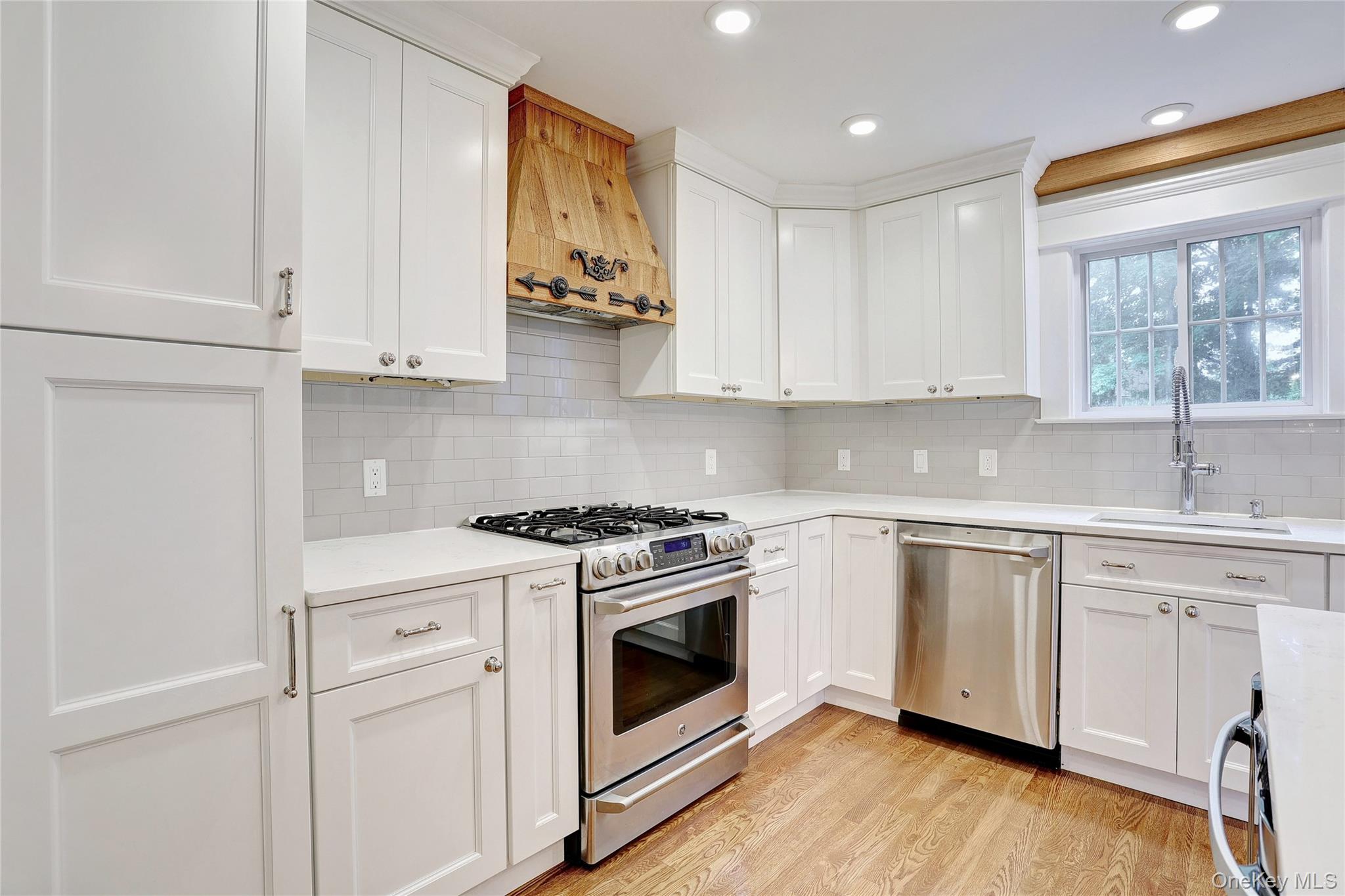 254 North Main Street New City, NY 10956 - Photo 10 of 37 a kitchen with granite countertop white cabinets and white appliances