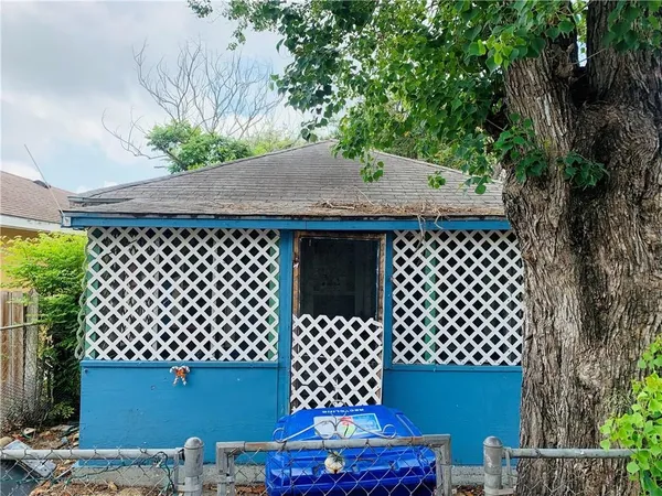 a backyard of a house with table and chairs