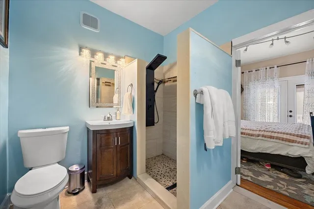 a bathroom with a toilet a sink and shower