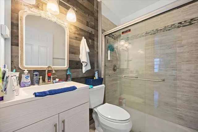 a bathroom with a sink a toilet and shower