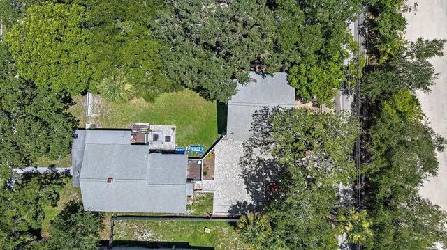 an aerial view of a house with yard and outdoor seating
