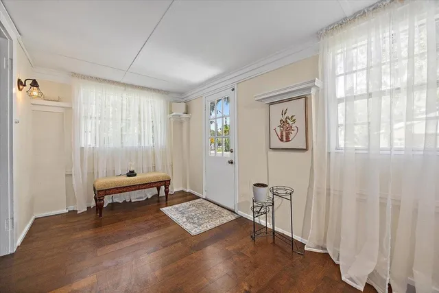 a view of a bedroom with furniture window and wooden floor