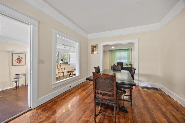 a dining room with furniture and wooden floor