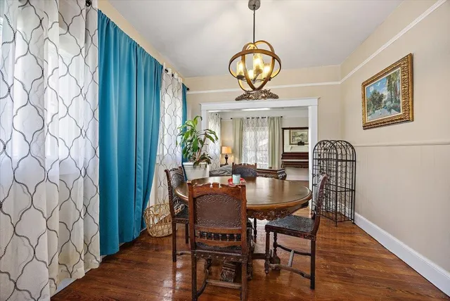 a view of a dining room with furniture wooden floor and chandelier