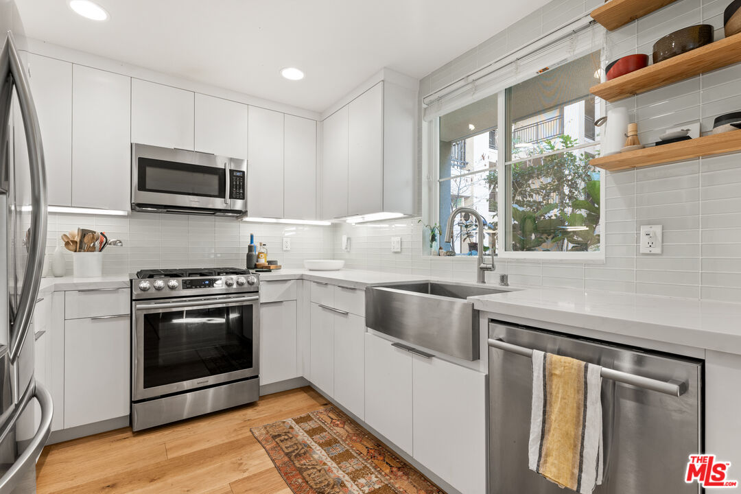 6020 South Seabluff Drive, Unit 131 Playa Vista, CA 90094 - Photo 11 of 30 a kitchen with granite countertop a sink and steel appliances