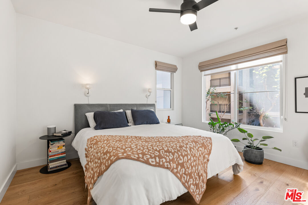 6020 South Seabluff Drive, Unit 131 Playa Vista, CA 90094 - Photo 13 of 30 a bedroom with a bed and wooden floor