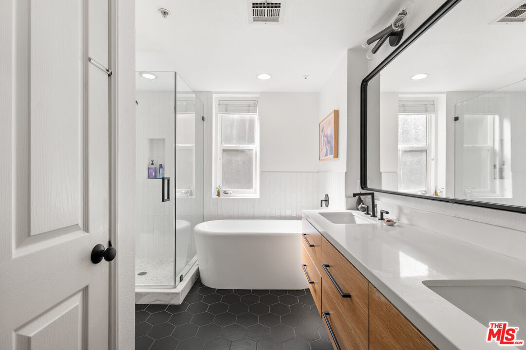 6020 South Seabluff Drive, Unit 131 Playa Vista, CA 90094 - Photo 16 of 30 a spacious bathroom with a double vanity sink a mirror and a bathtub