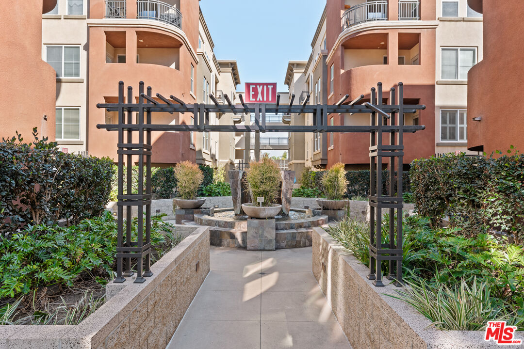 6020 South Seabluff Drive, Unit 131 Playa Vista, CA 90094 - Photo 29 of 30 a front view of a multi story residential apartment building with a yard
