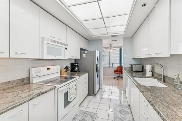 a kitchen with a sink a stove and cabinets