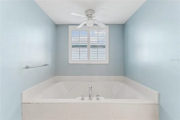 a bathroom with a glass shower door and a mirror