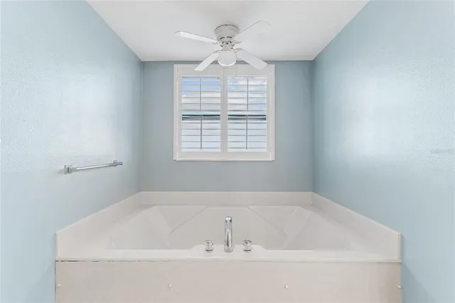 a bathroom with a glass shower door and a mirror