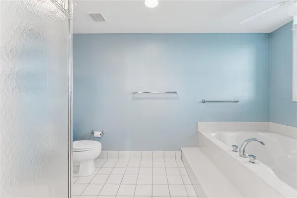 a view of washer and dryer with bathroom in the background