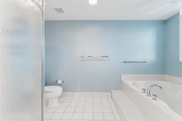 a view of washer and dryer with bathroom in the background