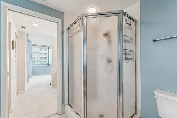 a bathroom with a granite countertop sink a toilet and a mirror