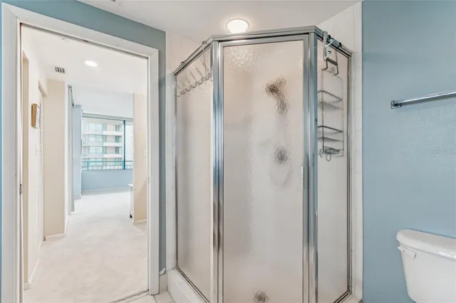 a bathroom with a granite countertop sink a toilet and a mirror