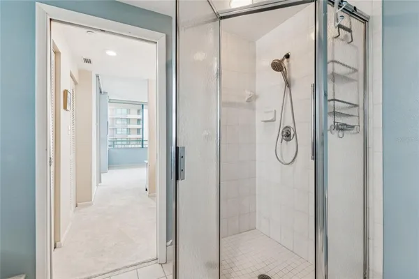 a bathroom with a granite countertop toilet a sink and a mirror