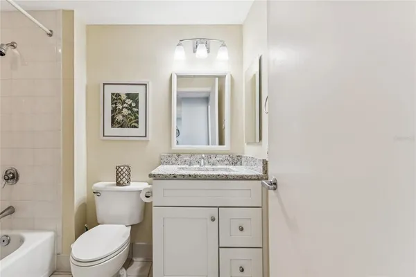 a bedroom with a bed and a lamp