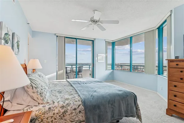 a bedroom with a bed and a large window