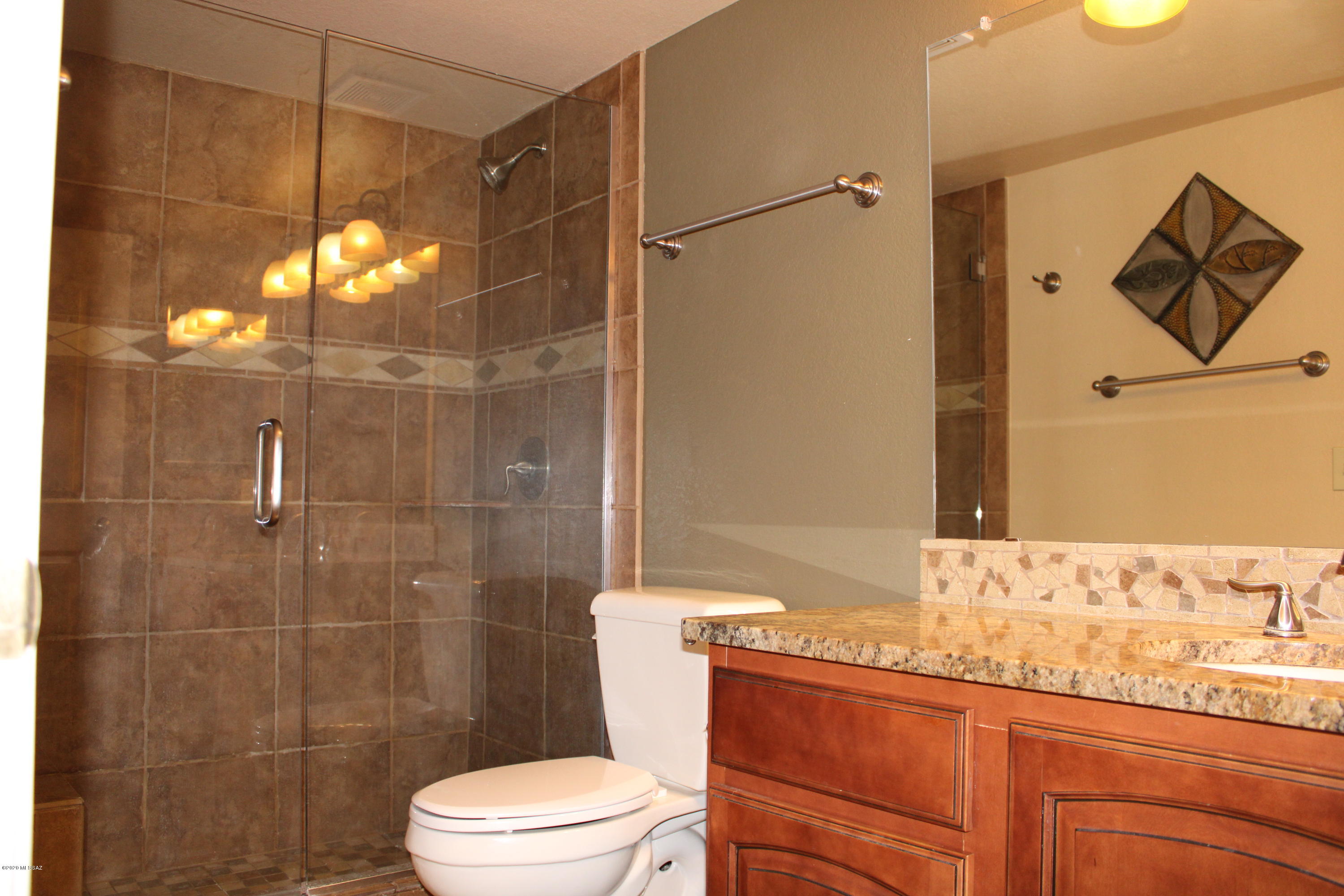 5751 North Kolb Road, Unit 36203 Tucson, AZ 85750 - Photo 14 of 25 a bathroom with a granite countertop sink toilet and shower