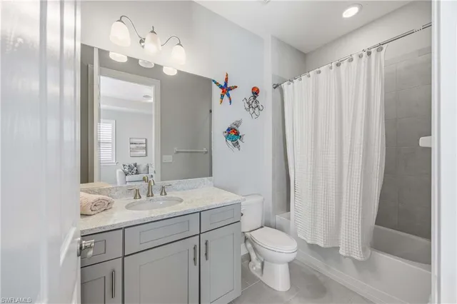 a bathroom with a sink vanity mirror and toilet