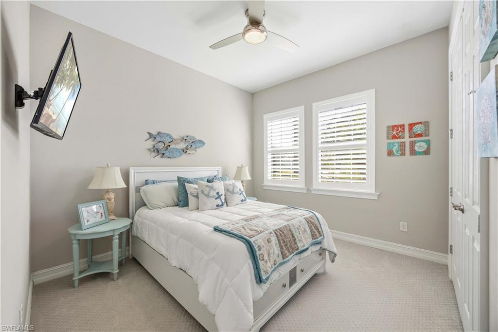14748 Windward Lane Naples, FL 34114 - Photo 21 of 47 a bedroom with a bed lamp and a window