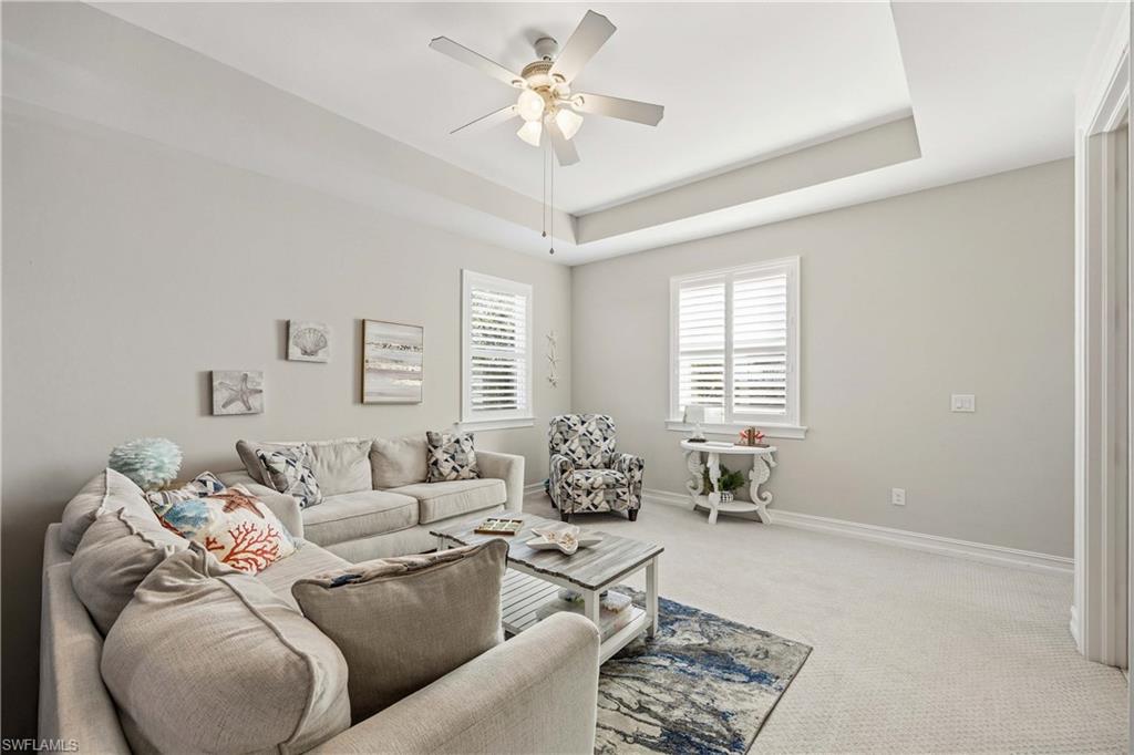 14748 Windward Lane Naples, FL 34114 - Photo 24 of 47 a living room with furniture and a large window
