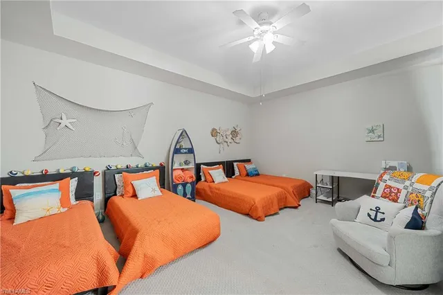 a bedroom with two beds and a chandelier