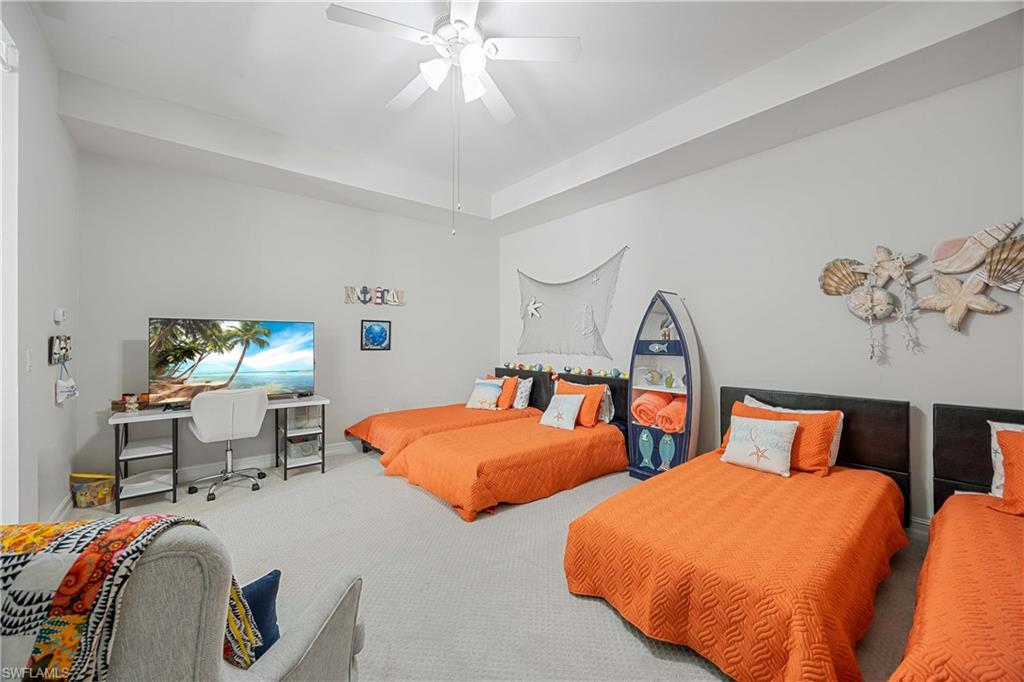 14748 Windward Lane Naples, FL 34114 - Photo 26 of 47 a bedroom with two beds and a chandelier